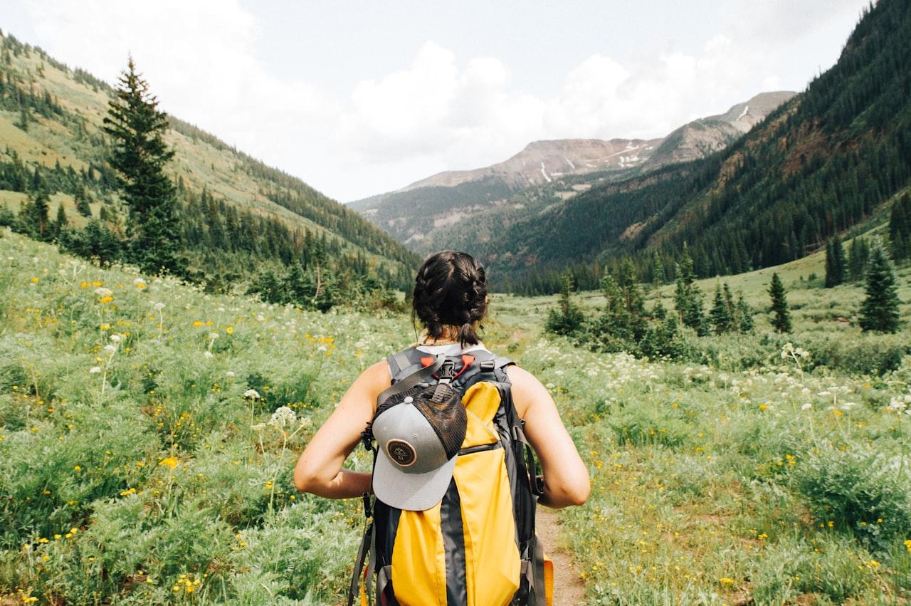 Hiker looking out at mountain valley